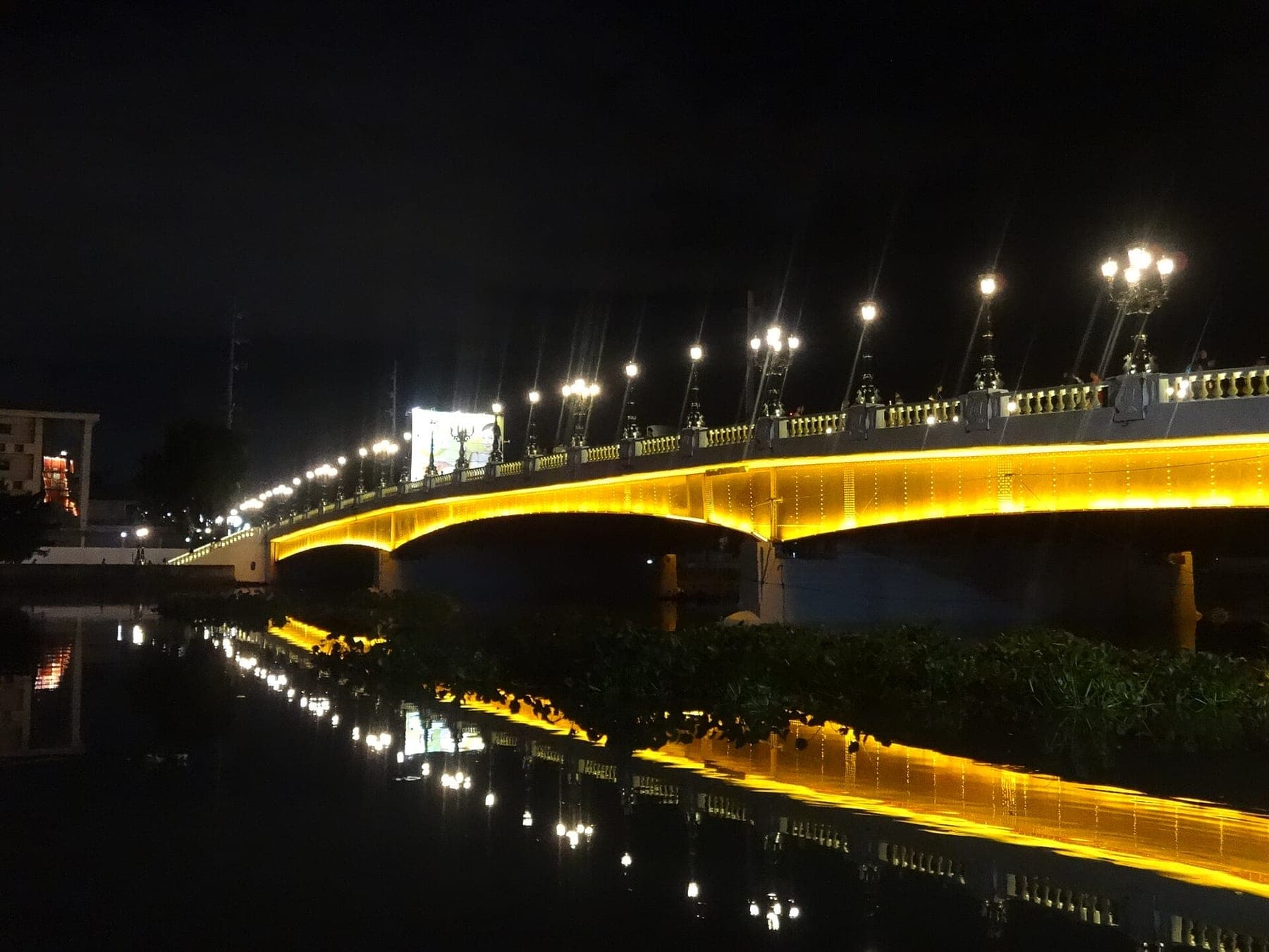The restored heritage Jones Bridge over the Pasig River in Manila, lit at night